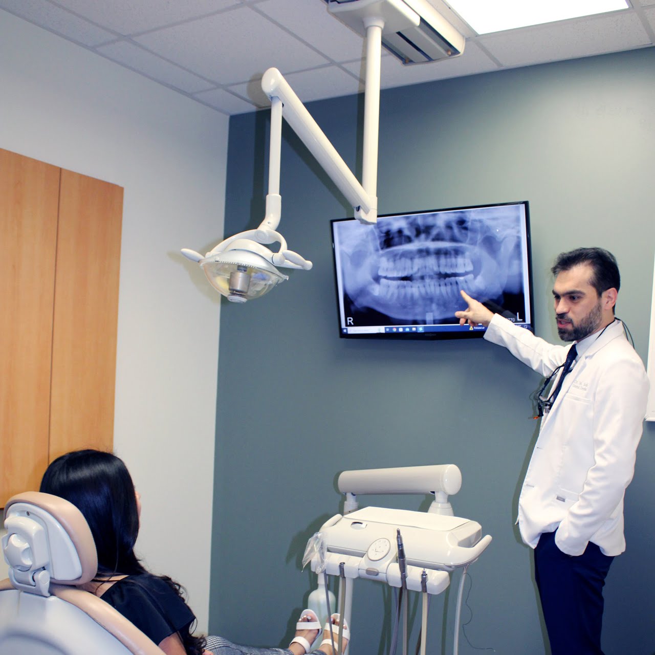 A Trinity dentist speaking with a patient